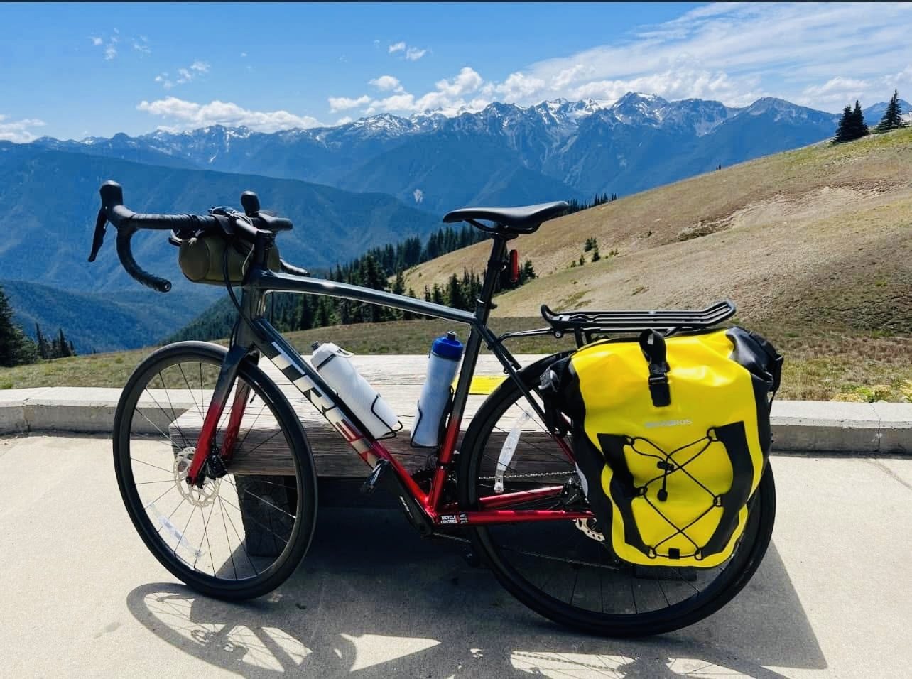 Touring bike with yellow panniers on a mountain pass